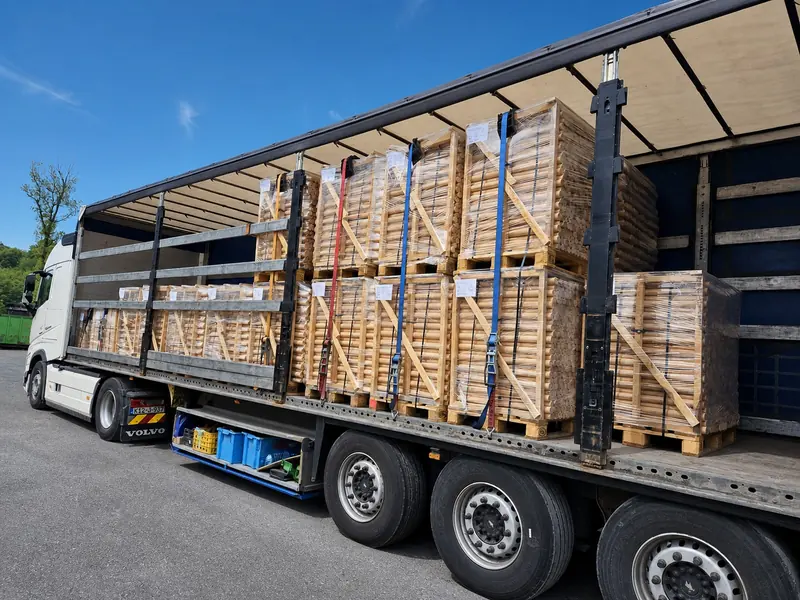 Trailer loaded with crated pallets of turned beech elements for cork production