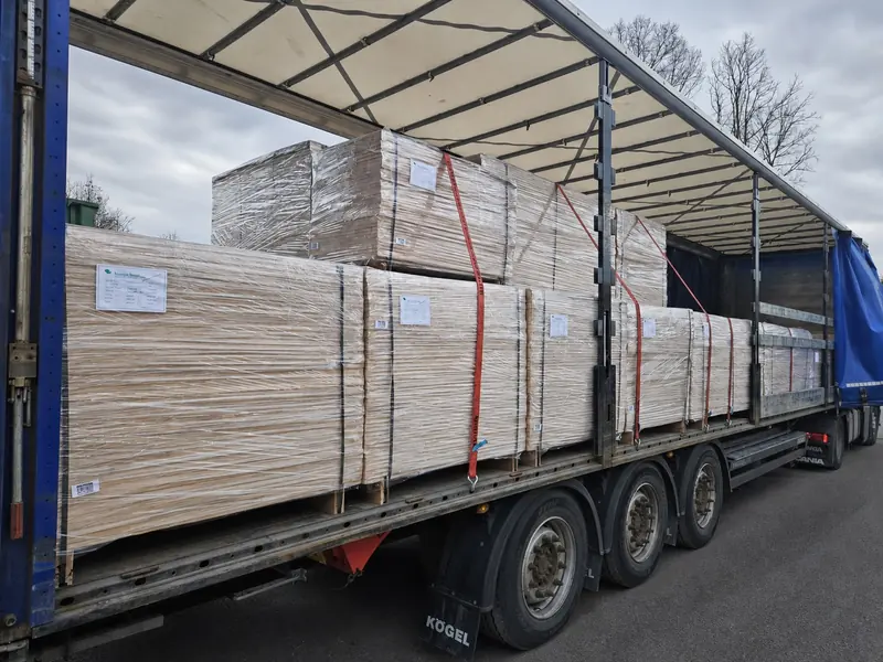 Labelled pallets of wood elements loaded and strapped for dispatch