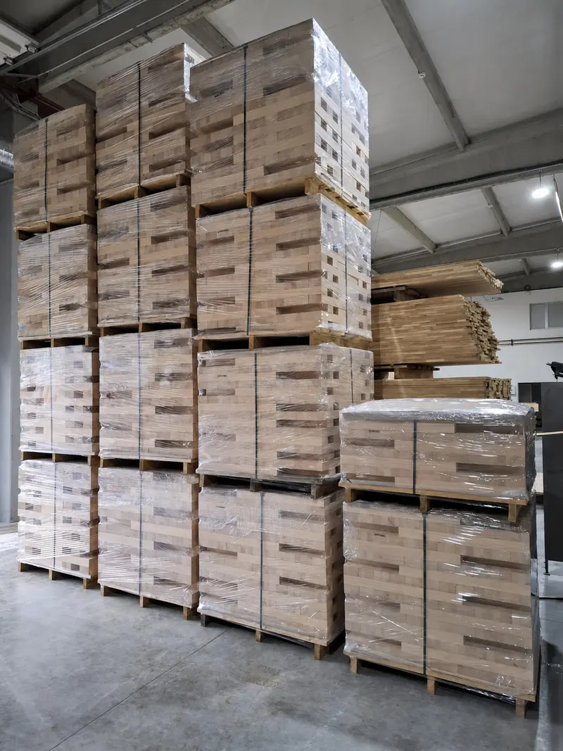 Rows of wrapped element pallets stacked to the roof in the warehouse