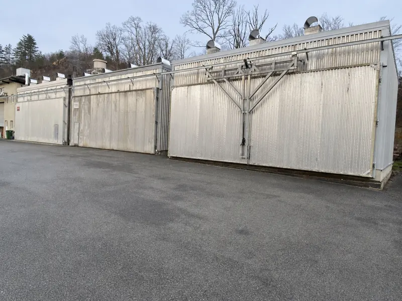 Exterior of the metal-clad kiln-drying chambers with ventilation stacks