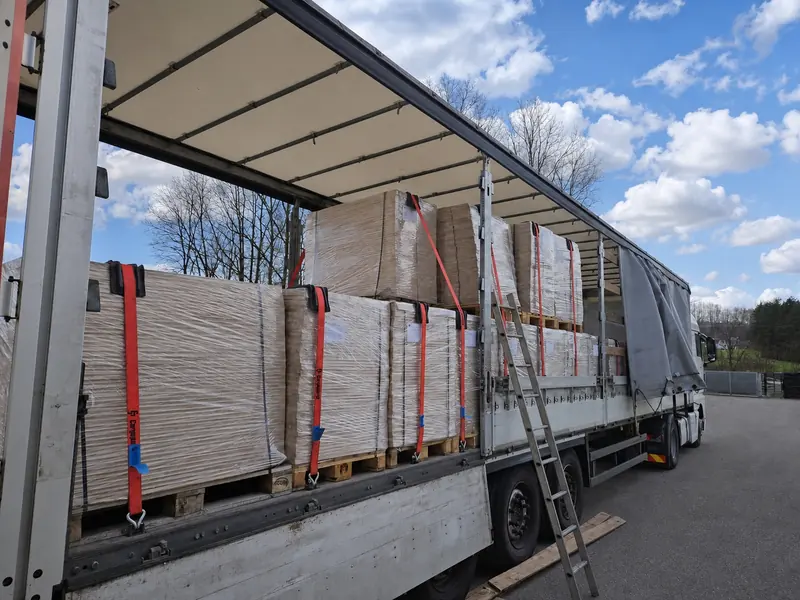 Palletised element packs strapped on a trailer with a loading ladder alongside