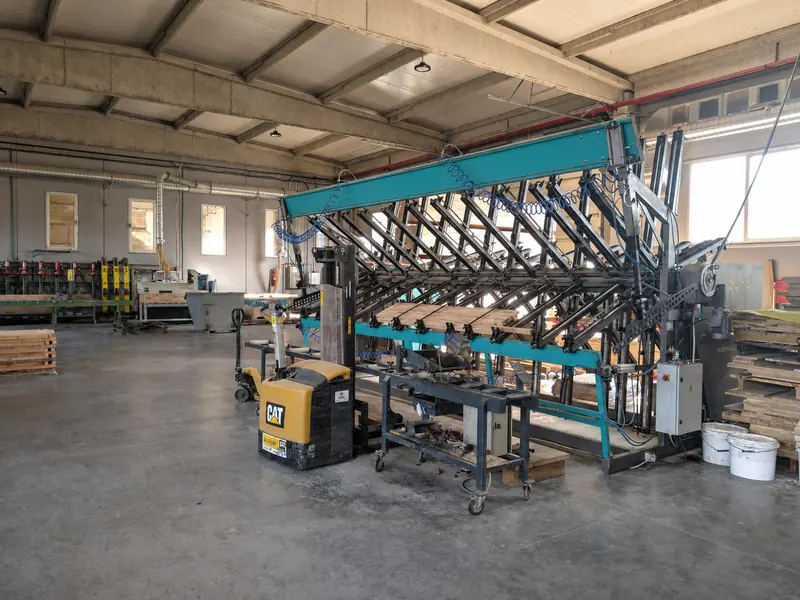 Clamping press for edge-glued panels standing in the production hall