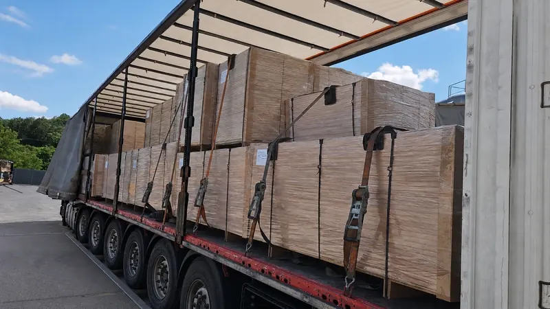 Wrapped panel packs loaded and strapped for export transport