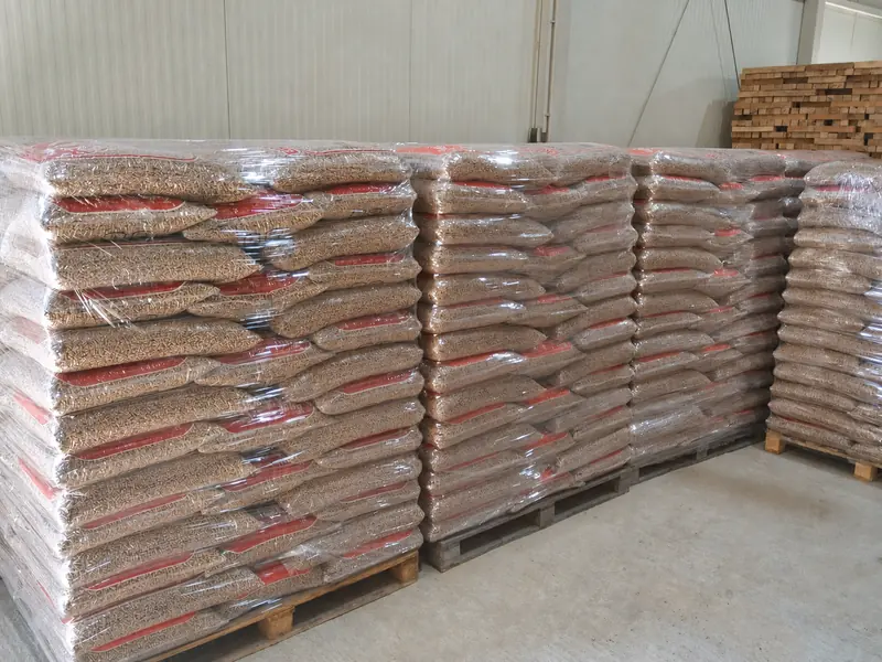 Foil-wrapped pallets of bagged wood pellets stacked in the Pašinac warehouse