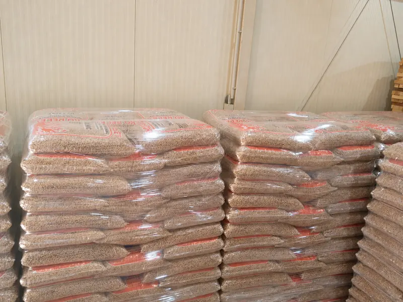Stacked pallets of shrink-wrapped 15 kg Eko Pelet bags ready for distribution