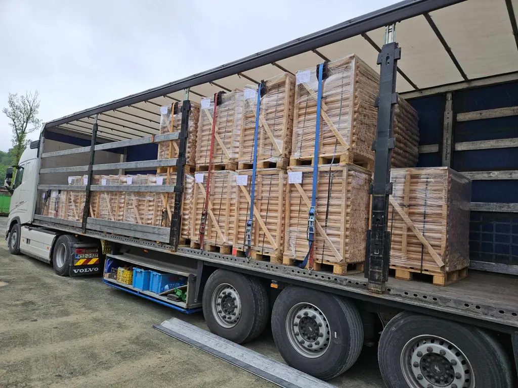 Warehouse stacked with palletised bed-slat and bed-base elements ready for dispatch