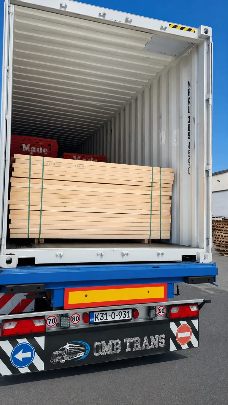Bundles of kiln-dried cut-to-size lumber loaded inside a shipping container