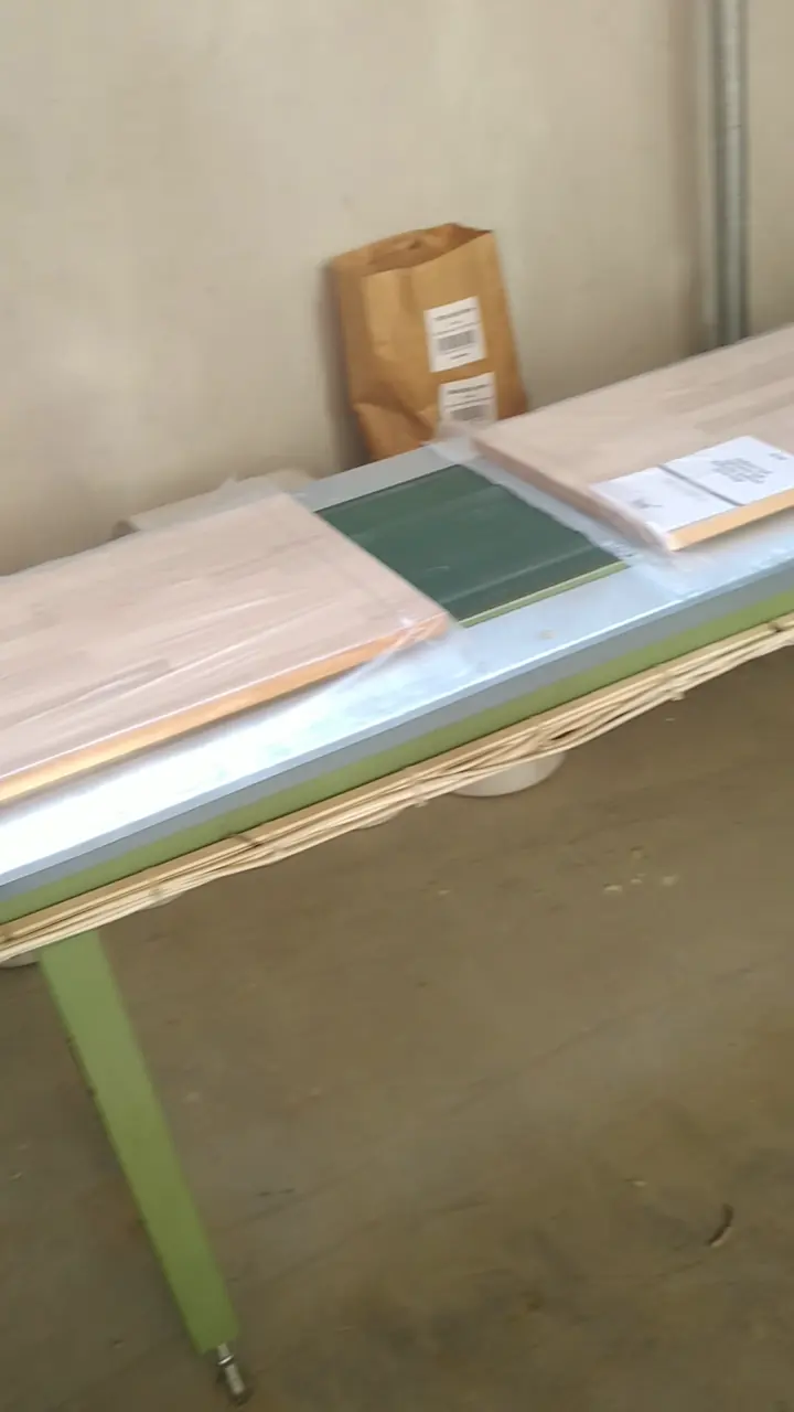 Labelled and foil-wrapped packs of edge-glued beech panels stacked in the hall